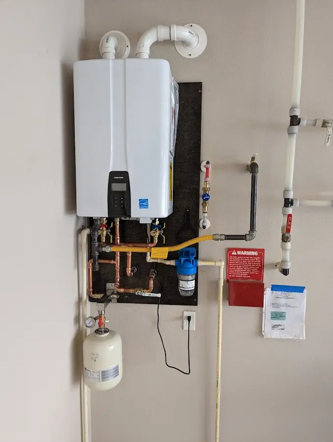 Professional plumber installing copper piping in a Pavilion home